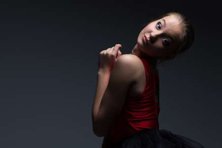 Photo of attractive young girl on dark backgroundの写真素材