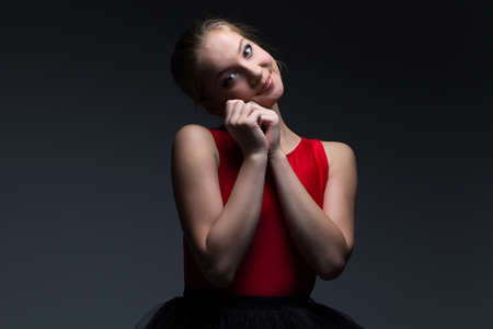 Image of smiling young girl on dark backgroundの写真素材