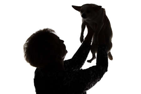 Silhouette of a woman with the dog on white backgroundの写真素材