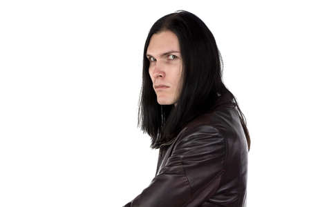 Photo of man with stern look and long hair on white backgroundの写真素材