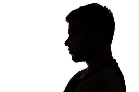 Image of muscular man\'s silhouette in profile on white backgroundの写真素材