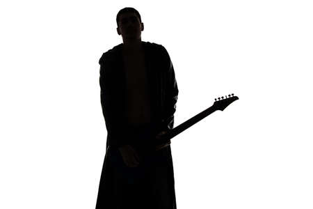Photo of young man\'s silhouette with the guitar on white backgroundの写真素材