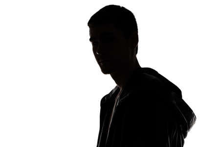 Portrait of man\'s silhouette - looking at camera on white backgroundの写真素材