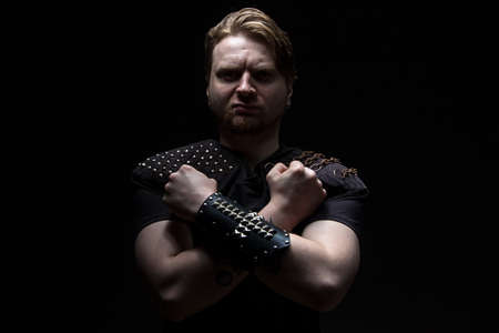 Image of the man with arms crossed on black backgroundの写真素材