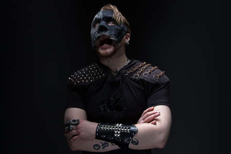 Image of the screaming blond man in mask on black background