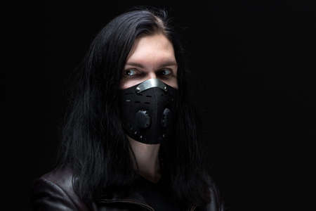 Image of the brunet man in mask on black backgroundの写真素材