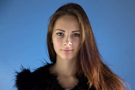 Photo of the teenage girl on blue backgroundの写真素材