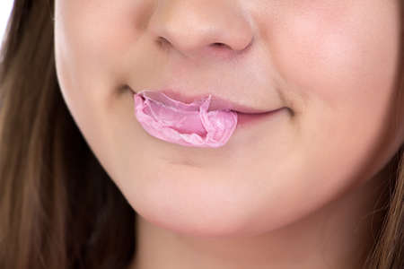 Photo of bursted bubble on teenage girls lipsの写真素材
