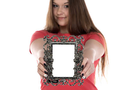 Photo of teenage girl showing photo frame on white backgroundの写真素材