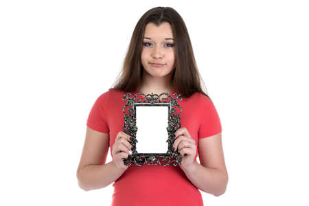 Image of sad teenage girl with photo frame on white backgroundの写真素材