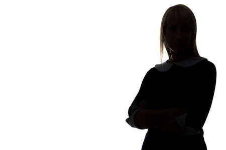 Silhouette of woman with arms crossed on white background, half-turnedの写真素材