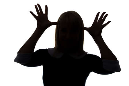 Silhouette of woman with palms on head on white backgroundの写真素材