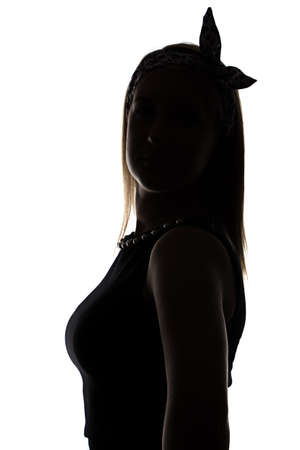 Silhouette of standing looking back woman on white backgroundの写真素材