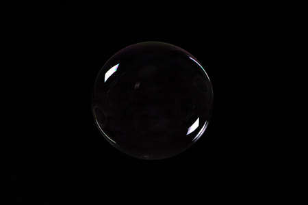 Photo of soap bubble on black backgroundの写真素材