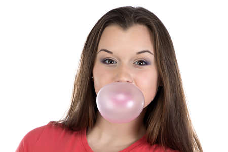 Smiling teenage girl and bubble gum on white backgroundの写真素材