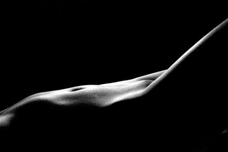 Black and white photo of the sexy womans body on black backgroundの写真素材