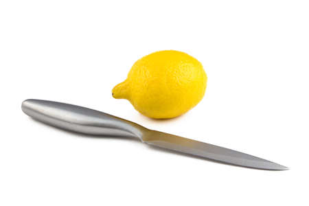 Photo of chrome knife and lemon on white backgroundの写真素材