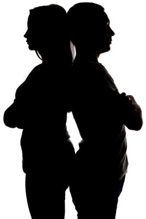 Two teenagers looking in different sides on white backgroundの写真素材
