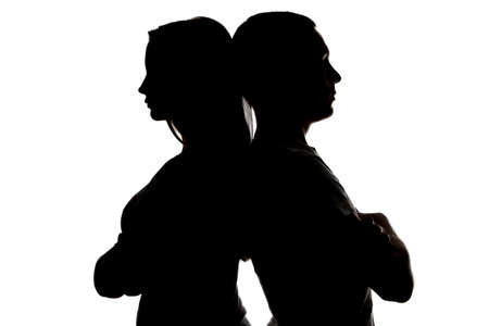 Photo of silhouette teenagers looking in different sides on white backgroundの写真素材