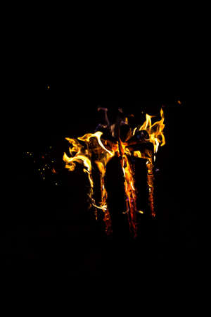 Image of hot log with flame by night on black backgroundの写真素材