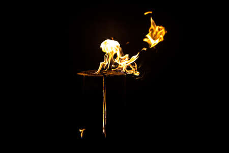 Image of yellow flame by night on black backgroundの写真素材