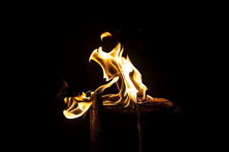 Photo of flaming log on black backgroundの写真素材