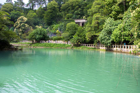 Photo of blue water in pond among trees, summer in Abkhaziaのeditorial素材