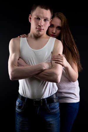 Photo of strong boy and girl on black backgroundの写真素材