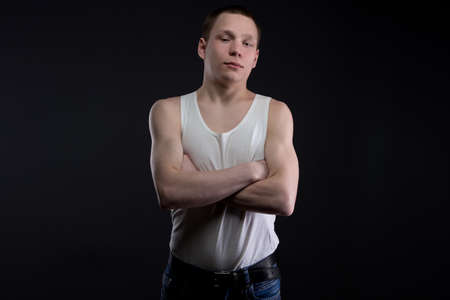 Photo of teenager with arms crossed on black backgroundの写真素材
