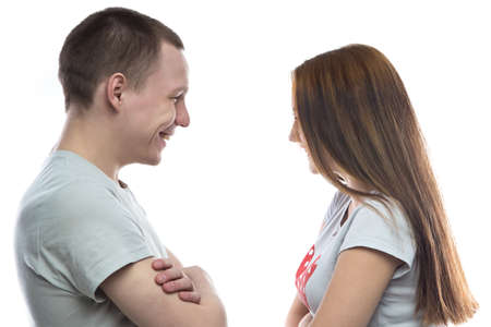 Photo of smiling teenage boy and girl on white background