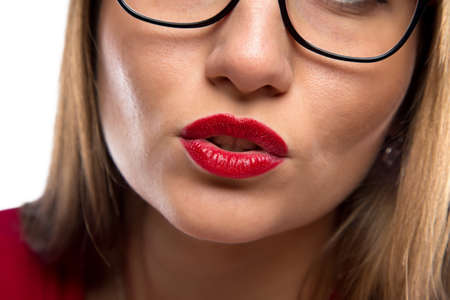 Photo of woman's face, red lips on white backgroundの写真素材