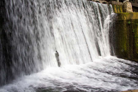 Image of the waterfall with foaming water, in the summerの写真素材