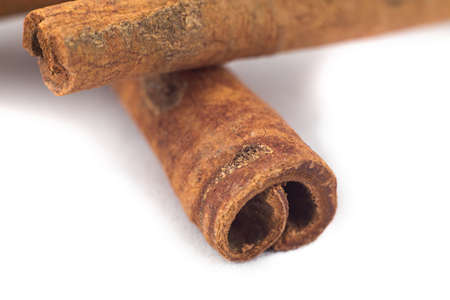 Photo of cinnamon sticks, macro shot on white background