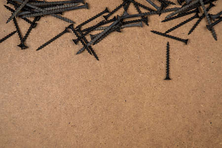Wood screws on fibreboard, located at the topの写真素材