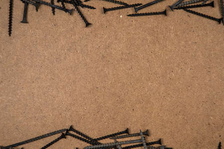 Wood screws on fibreboard, located at the top and bottom
