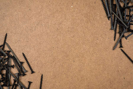Screws on the diagonal of plate. Construction background with tools.の写真素材