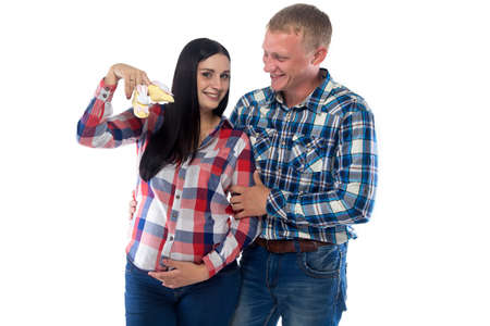 Pregnant woman and her husband laughing. Isolated photo with white background.の写真素材