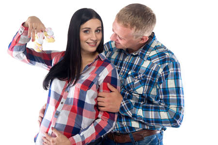 Pregnant brunette woman and her husband. Isolated photo with white background.の写真素材