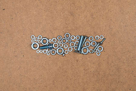 Minus from bolts and nuts. Photo of mozaic sign on wood background.の写真素材