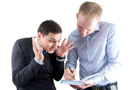 Two businessmans on white writting something. Isolated photo with white background.の写真素材