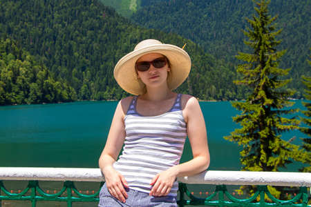 Happy young woman with panama hat looking at camera