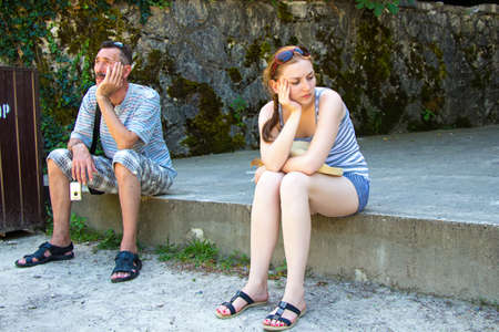 Tourists are tired sitting and waiting. Travel photo in the summer.の写真素材
