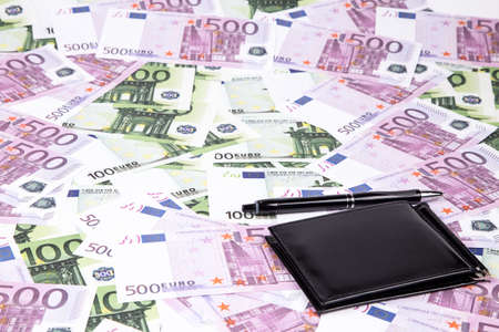 Texture of one and five hundreds euro and pen. Photo of background.の写真素材