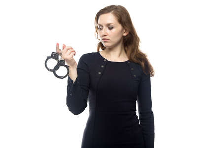 Thinking woman with handcuffs, isolated on white backgroundの写真素材