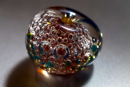 Macro shooting of colour glass bead on grey background