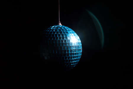 Disco ball in shadow on black backgroundの写真素材