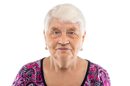Serious elderly woman with white hair on white backgroundの写真素材