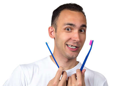 Brunette man with toothbrushes on white background