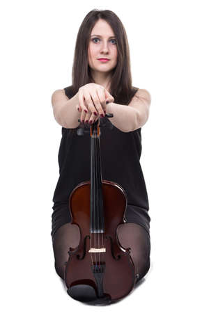 Sitting young brunette woman with violin on white backgroundの写真素材