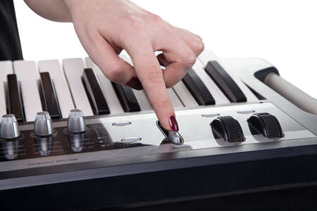 Girl playing on piano on white backgroundの写真素材